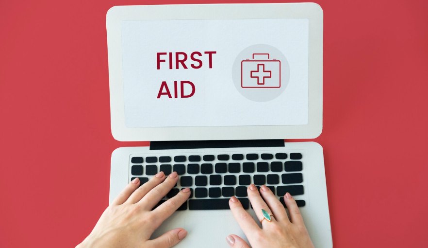 A laptop showing a first aid icon, a symbol of emergency preparedness