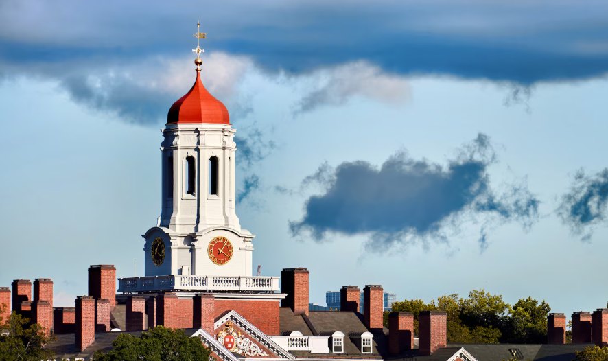 A school clock tower with a red dome under a blue sky